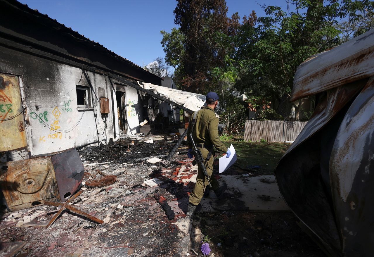 A soldier walks among the debris of a burnt house at Kibbutz Nir Oz in southern Israel, on November 21, 2023.