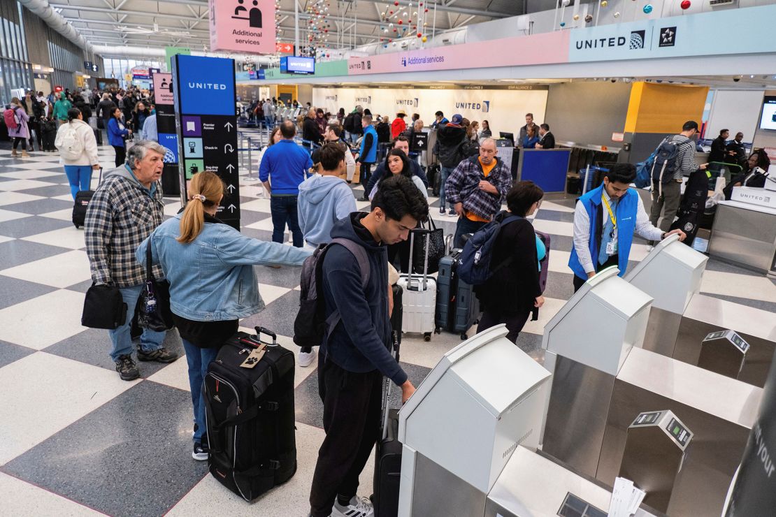 People check in for flights ahead of the Thanksgiving holiday at O’Hare International Airport in Chicago on November 22, 2023.