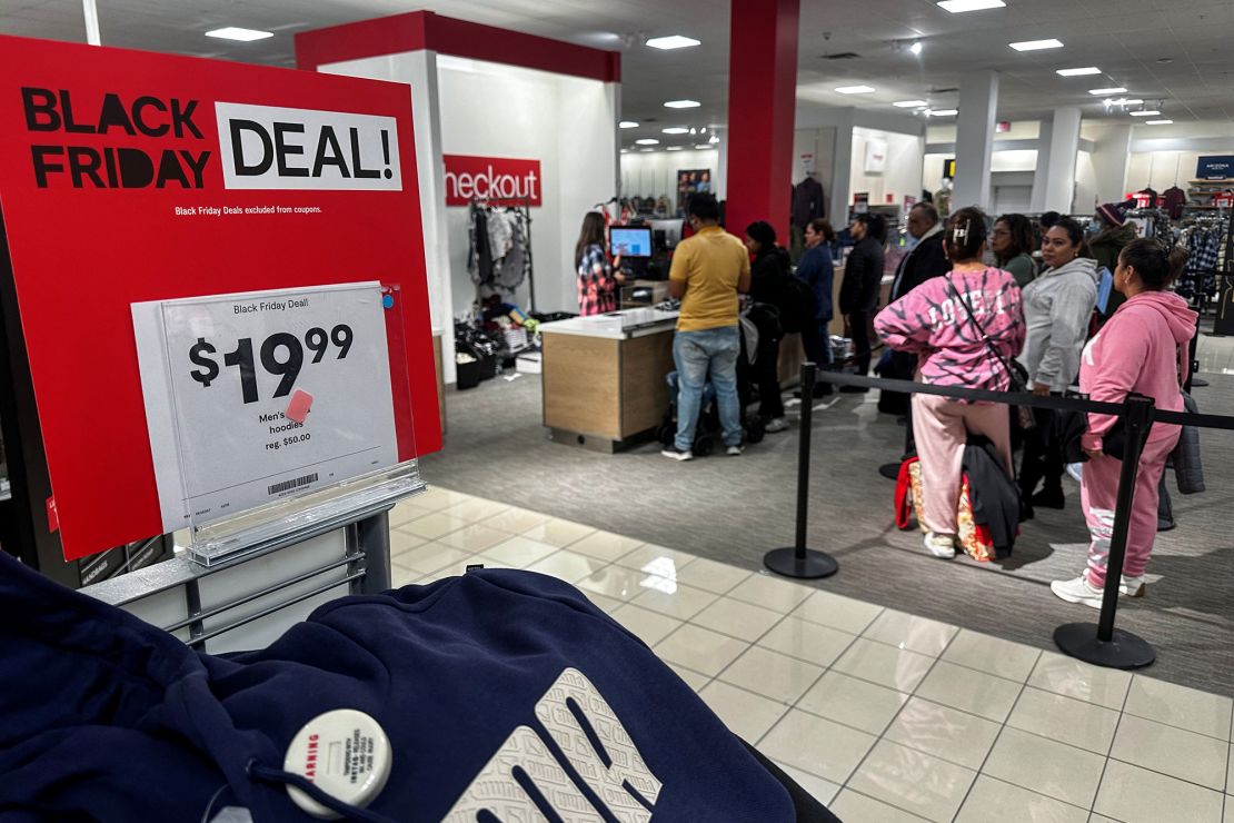Shoppers wait in line to make purchases during Black Friday deals at JCPenney department store at Roosevelt Field mall in Garden City, New York.