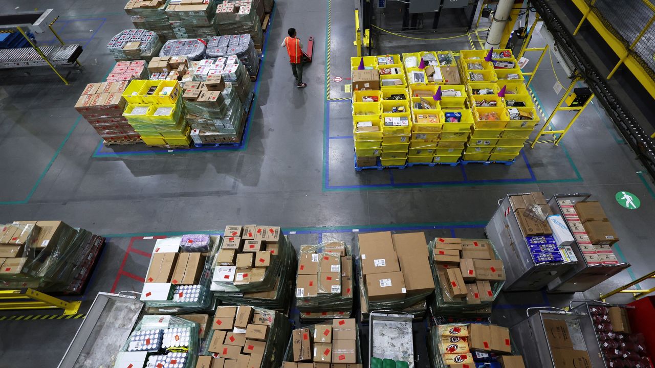 A worker stands amid stacks of products during Cyber Monday at the Amazon's fulfillment center in Robbinsville, New Jersey, U.S., November 27, 2023.