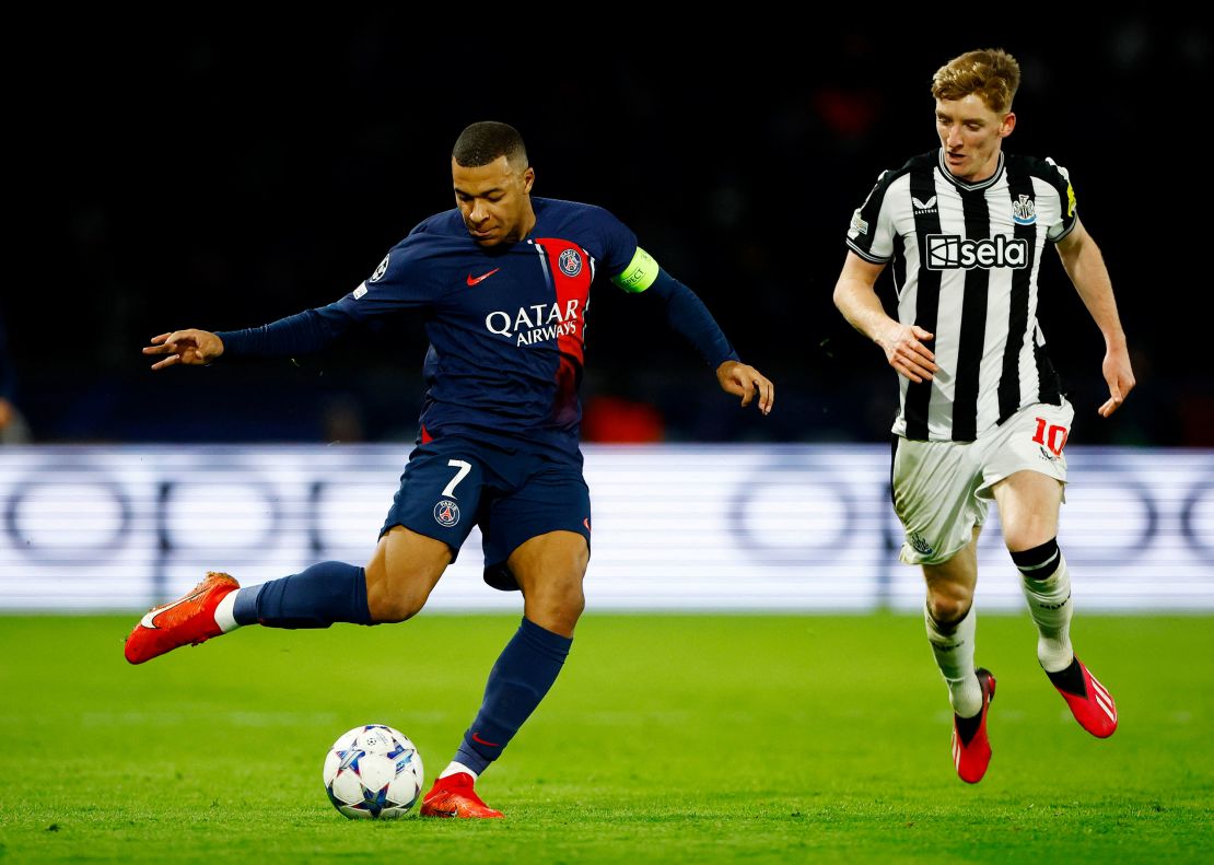 Paris St Germain's Kylian Mbappé in action with Newcastle United's Anthony Gordon on November 28, 2023.