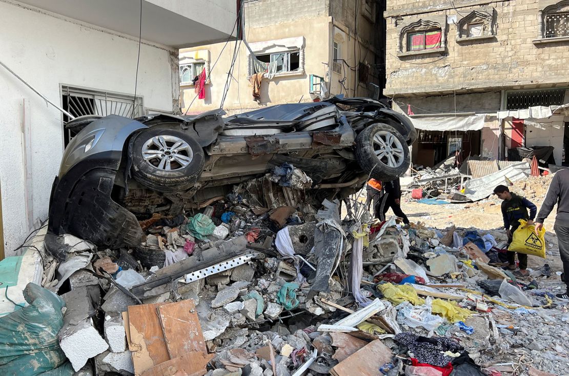 A damaged car sits on rubble following an Israeli raid at Kamal Adwan hospital, in the northern Gaza Strip December 16, 2023