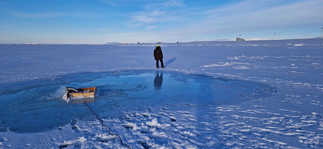 A member of the Real Ice team testing the submersible pump during field trials in Nome, Alaska, in February 2023.