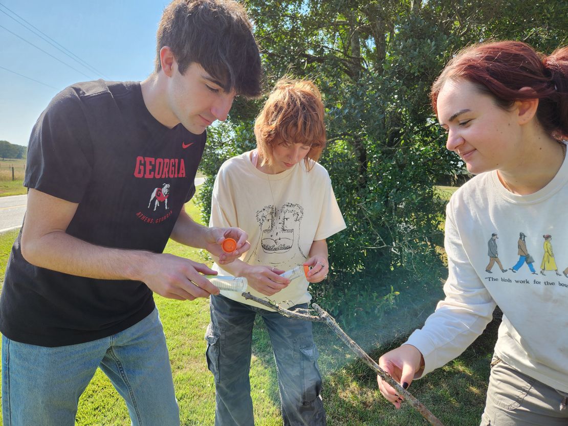 University of Georgia ecology students and study coauthors Kade Stewart, Caitlin Phelan and Alexa Schultz handle a Jorō spider.