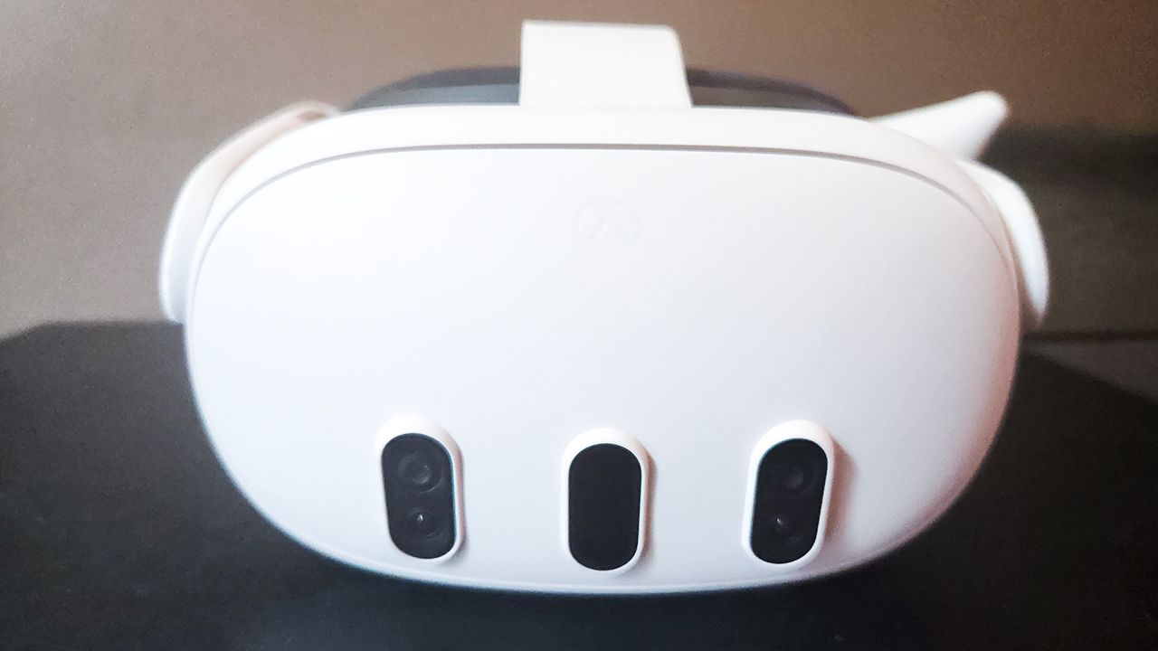 The front of a white virtual reality headset on a black table.