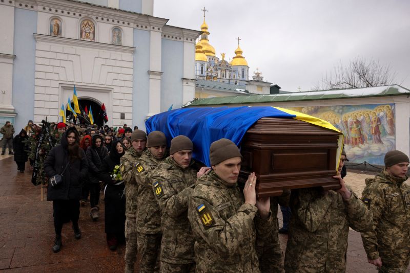 Soldiers carry the coffin of Ukrainian poet and serviceman Maksym Kryvtsov who was killed in action fighting against Russia's attack on Ukraine, during his funeral ceremony at St. Michael's Monastery in Kyiv, January 11, 2024.