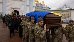 Soldiers carry the coffin of Ukrainian poet and serviceman Maksym Kryvtsov who was killed in action fighting against Russia's attack on Ukraine, during his funeral ceremony at St. Michael's Monastery in Kyiv, January 11, 2024.