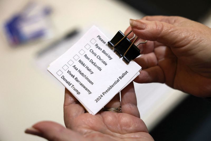 Sharon McNutt holds paper ballots before Republican caucus voters arrive to choose a presidential candidate, in Silver City, Iowa, on Monday.