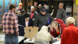 People arrive at a caucus site at Fellows Elementary School as voters get ready to choose a Republican presidential candidate in Ames, Iowa, on Monday.