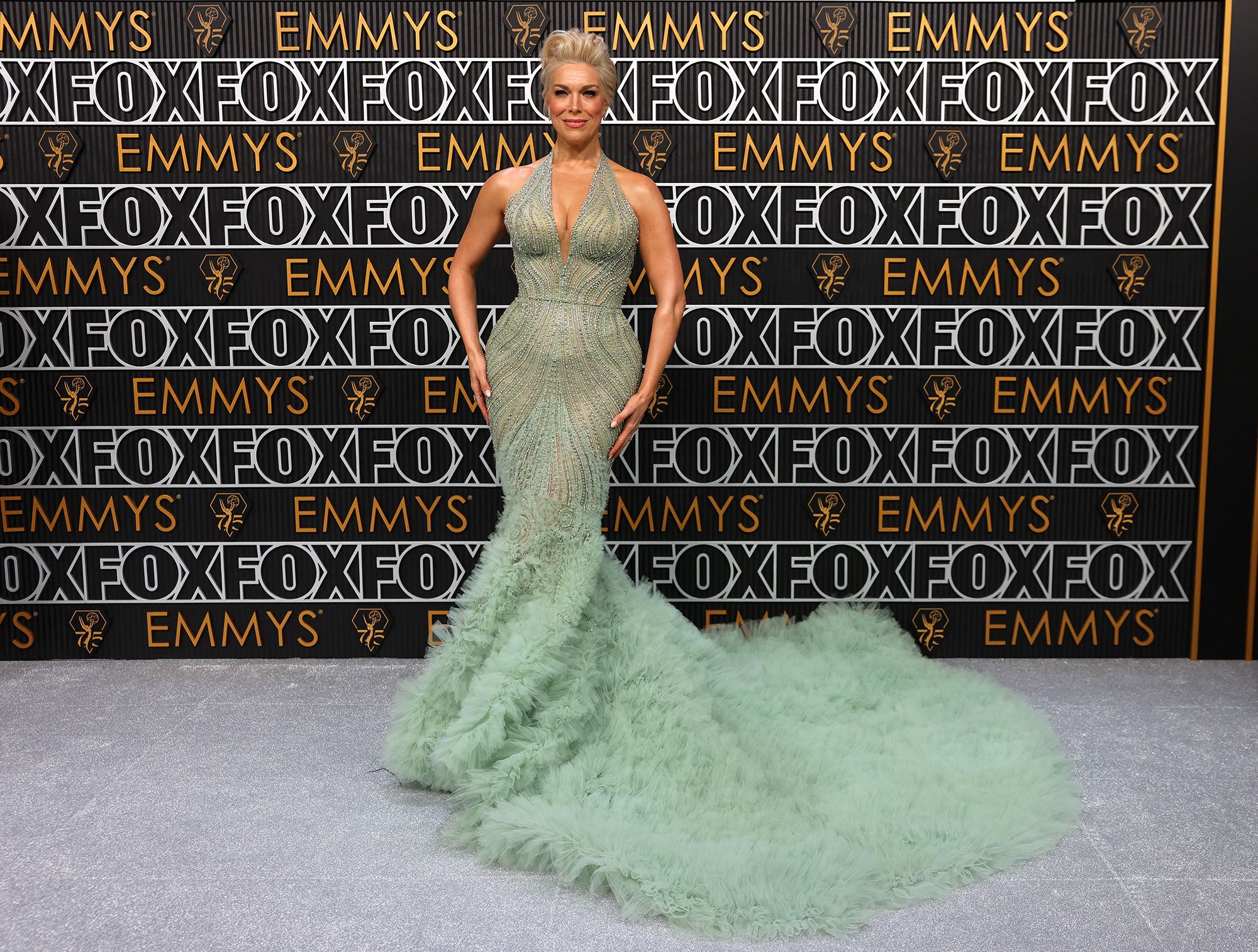 "Ted Lasso" star Hannah Waddingham looked glamorous in a soft mint green beaded Marchesa gown with ruffled tulle train.