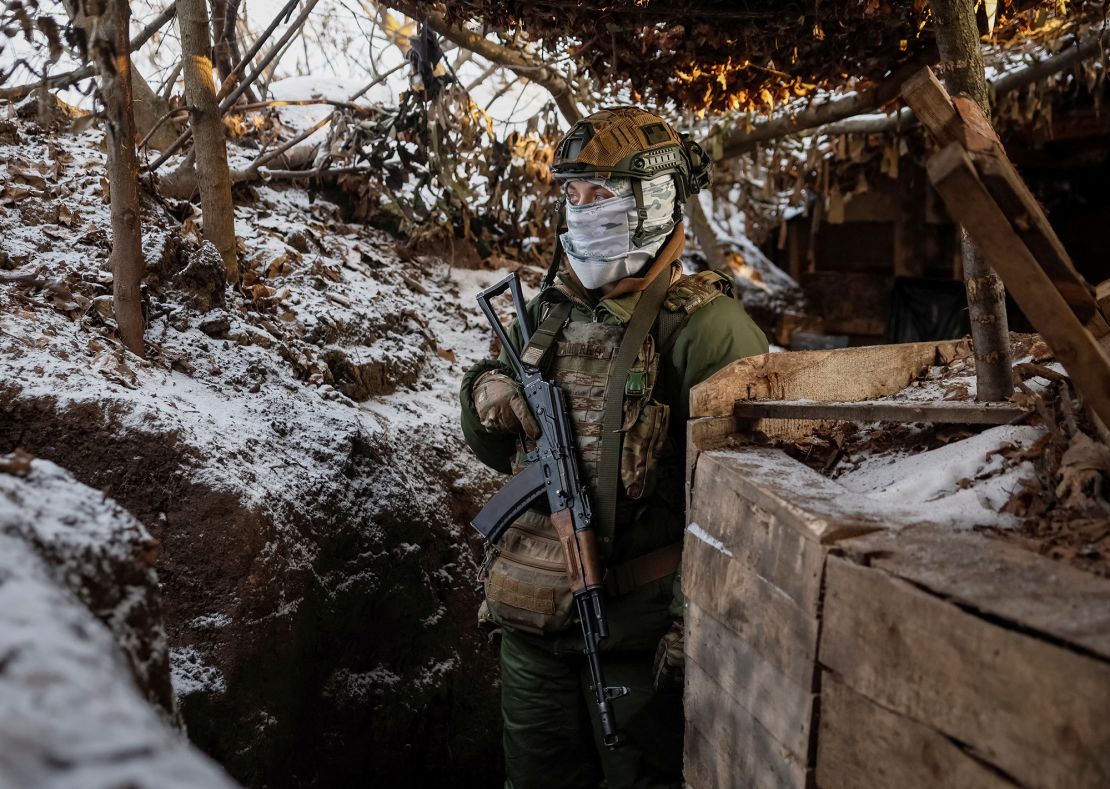 A Ukrainian serviceman stands at his position in a trench at a front line on the border with Russia in Sumy region, Ukraine, on January 20, 2024.