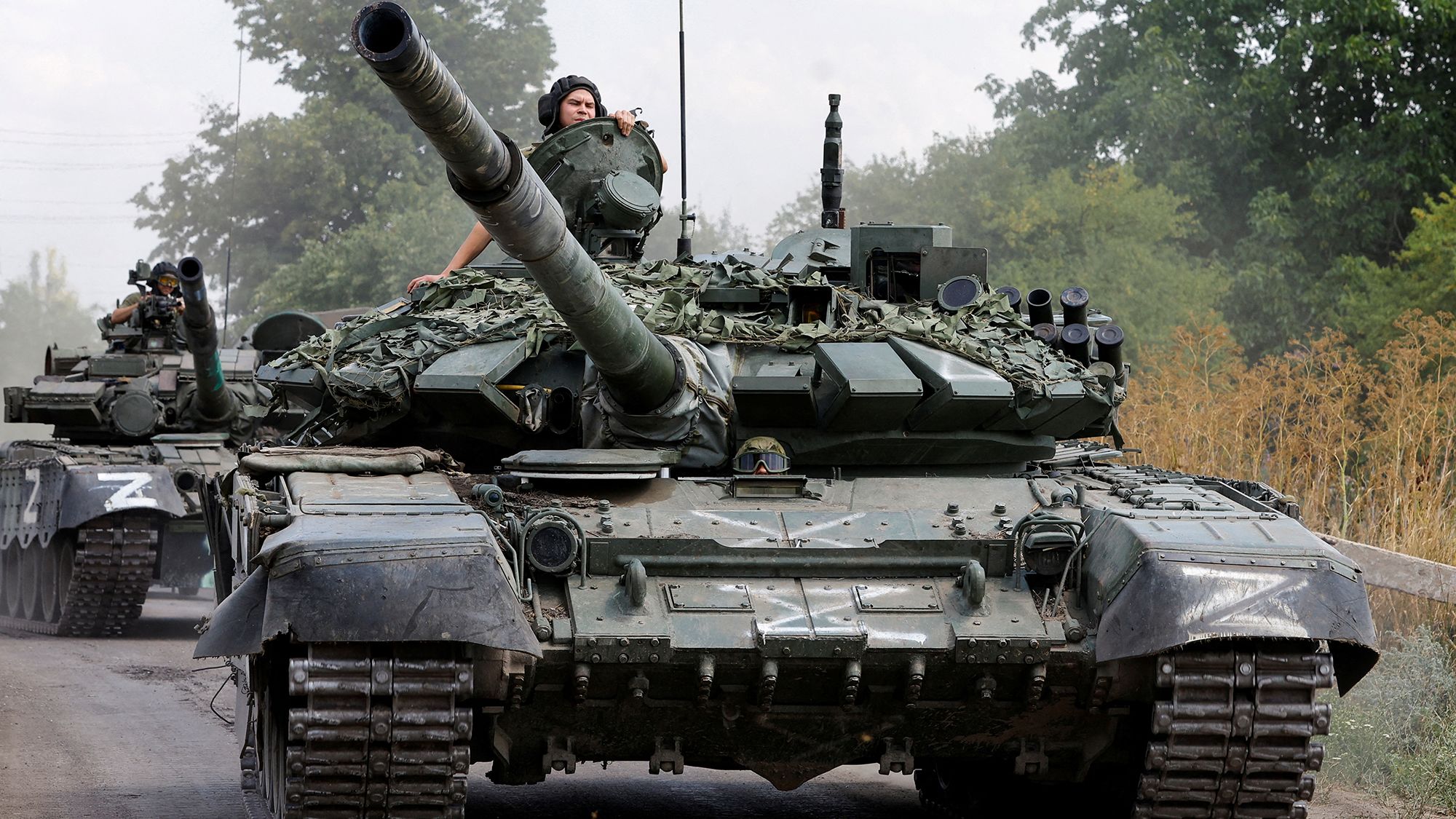 Russian tanks drive near the settlement of Olenivka in Donetsk region, Ukraine, July 2022.