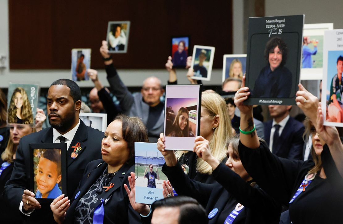 People hold up photographs and placards during the Senate Judiciary Committee hearing on online child sexual exploitation at the U.S. Capitol in Washington, U.S., January 31, 2024.