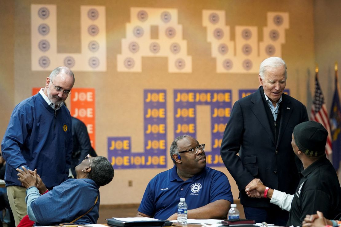 Biden and United Auto Workers chief Shawn Fain, left, meet with autoworkers in Warren, Michigan, on February 1, 2024.