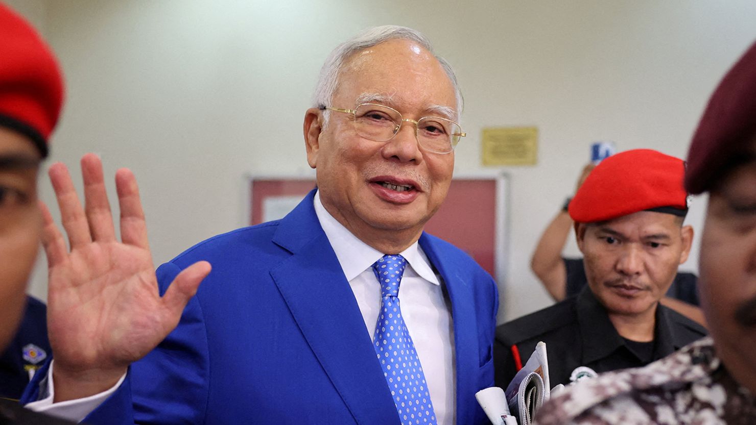Najib Razak is escorted by security personnel at a court in Kuala Lumpur on January 19, 2024.