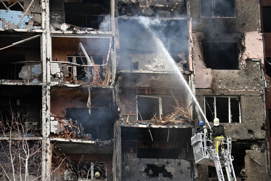 Firefighters are seen extinguishing a fire in a block of flats in the Holosiivskyi district in Kyiv, Ukraine, on February 7, 2024, after it was hit by falling Russian missile debris following a Russian strike.