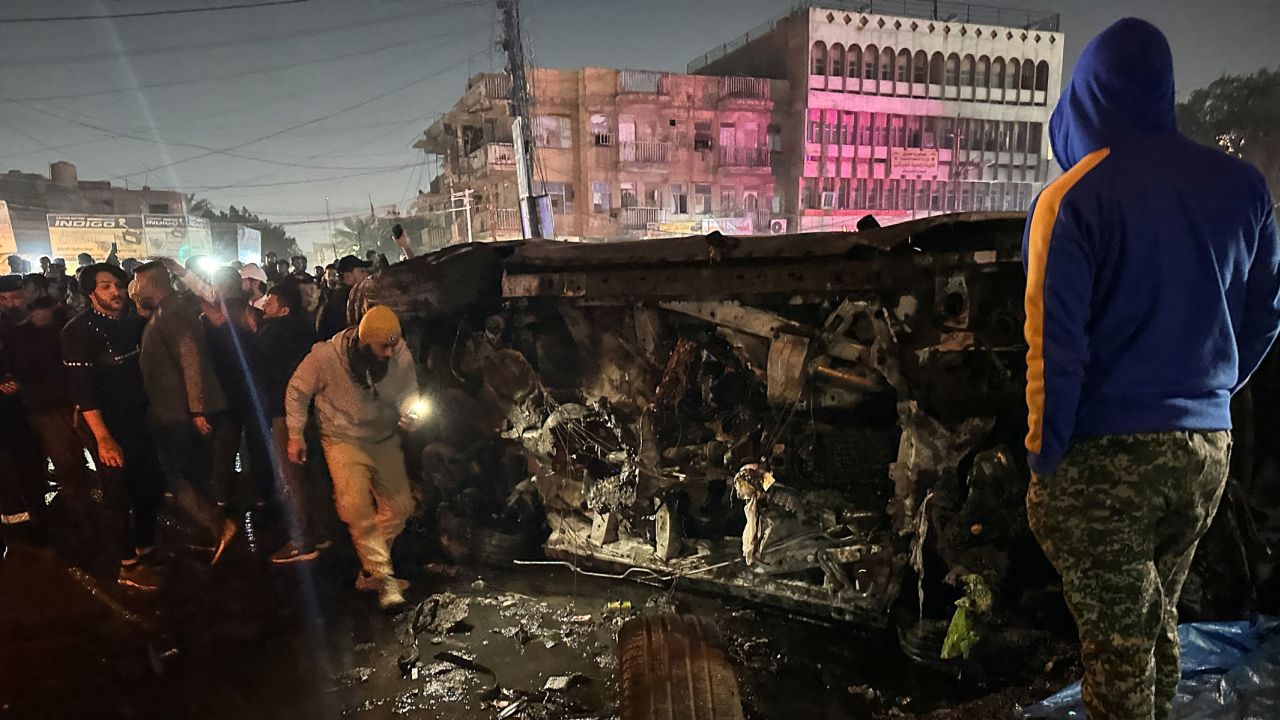 People inspect a vehicle, after what security sources said was a deadly drone strike, in Baghdad, Iraq on February 7.