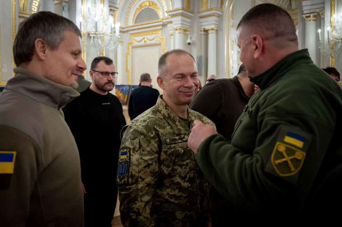 Commander in Chief of the Ukrainian Armed Forces Colonel General Oleksandr Syrskyi speaks with his predecessor Valerie Zaluzhnyi after awarding him with the Hero of Ukraine Gold Star.