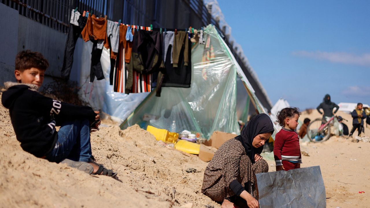 Displaced Palestinian woman Laila Abu Mustafa, who fled her house due to Israeli strikes, shelters at the border with Egypt, in Rafah in the southern Gaza Strip, February 10, 2024. REUTERS/Mohammed Salem