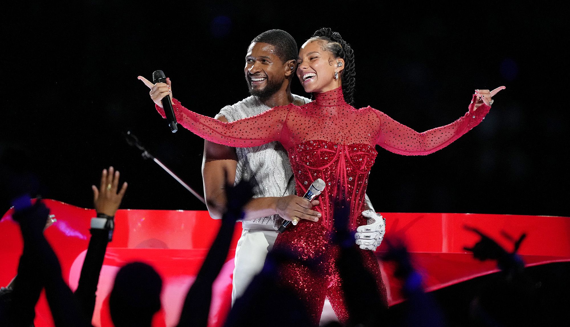 Usher and Alicia Keys, both wearing Dolce & Gabbana, perform during the halftime show at Super Bowl LVIII.