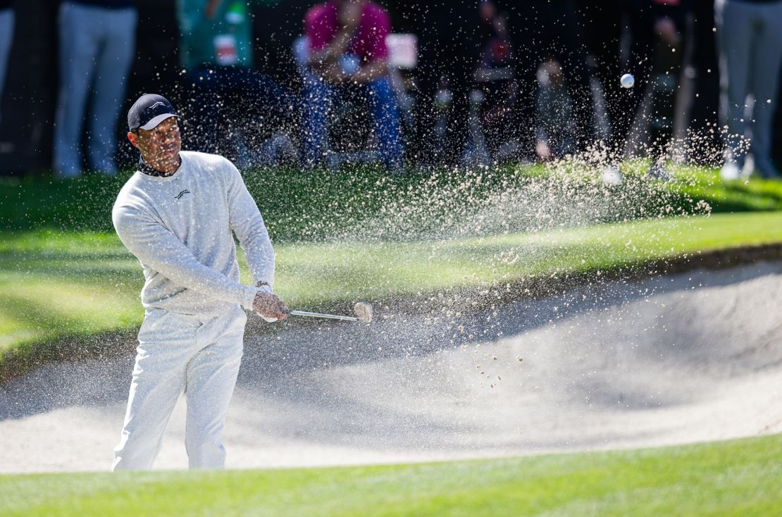 Woods hits from a bunker on the 10th hole during the first round of the Genesis Invitational.