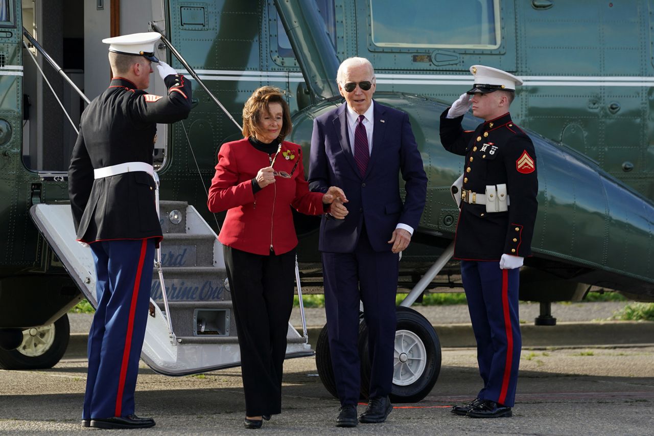 President Joe Biden and Rep. Nancy Pelosi walk after disembarking Marine One in San Francisco on February 21.