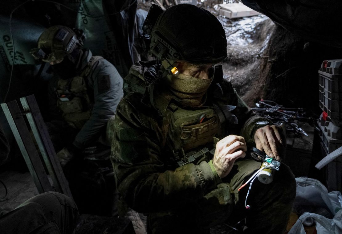 A Ukrainian soldier prepares a shell for a drone on the front line near Avdiivka on February 20, 2024.