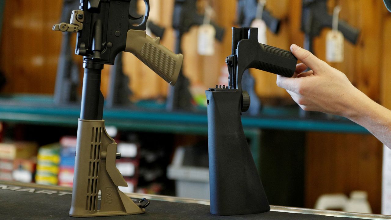 A bump fire stock, seen right, that attaches to a semi-automatic rifle to increase the firing rate is seen at Good Guys Gun Shop in Orem, Utah, in October 2017.