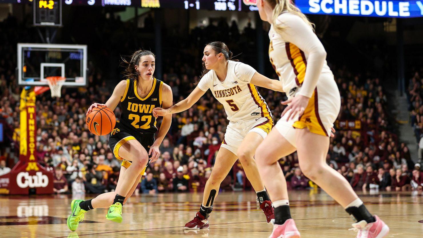 Iowa Hawkeyes guard Caitlin Clark dribbles while being defended by Minnesota Golden Gophers guard Maggie Czinano (5) during the second half at Williams Arena.