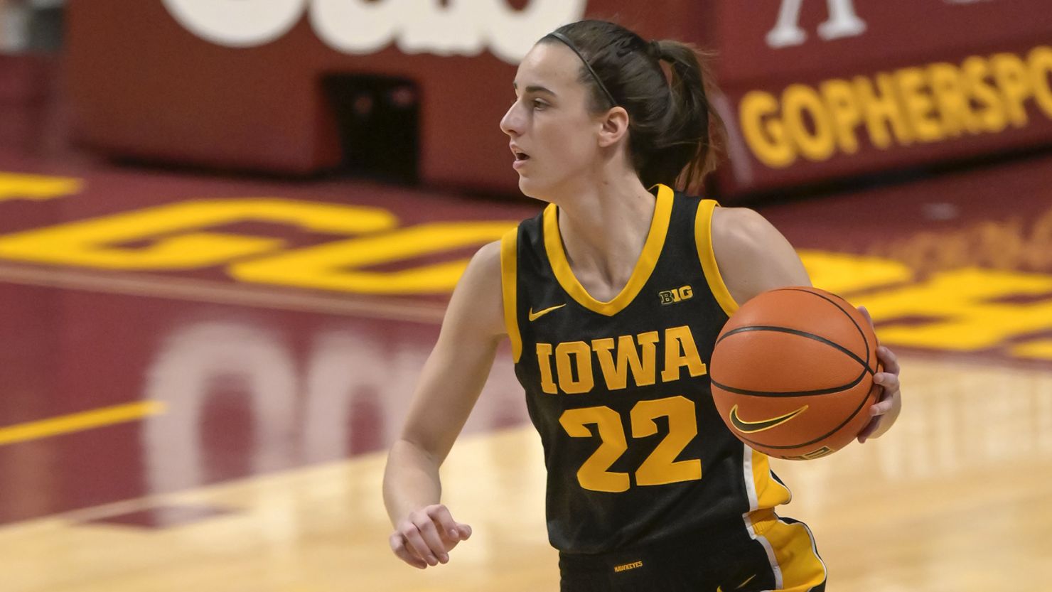 Iowa Hawkeyes guard Caitlin Clark (22) brings the ball up-court against the Minnesota Golden Gophers during the first quarter at Williams Arena.