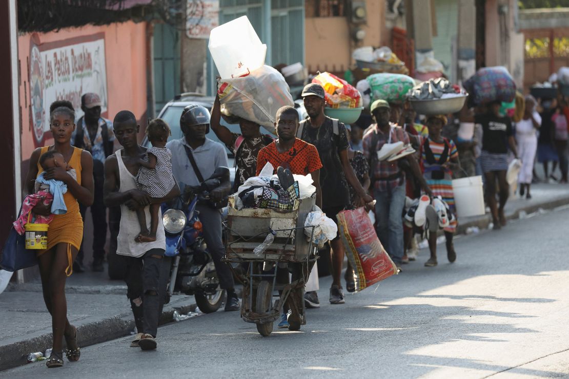 People flee their homes as police confront armed gangs in Port-au-Prince, Haiti, February 29, 2024.