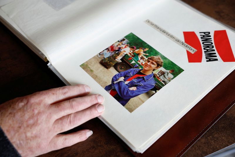 Bert Janssen looks at a photograph of himself as a younger man.