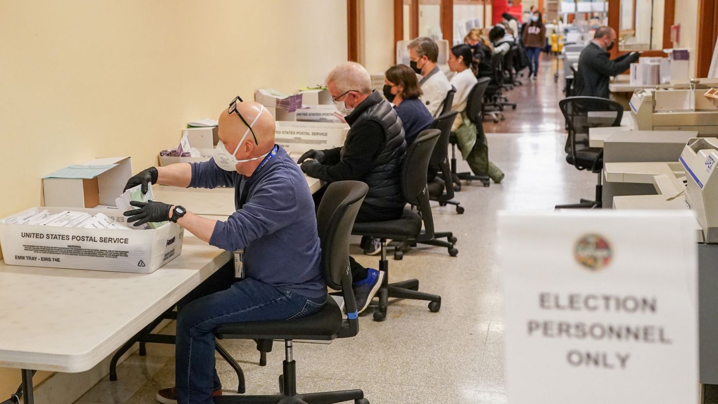 Election personnel process ballots at the San Francisco City Hall voting center during early voting before the Super Tuesday primary election.
