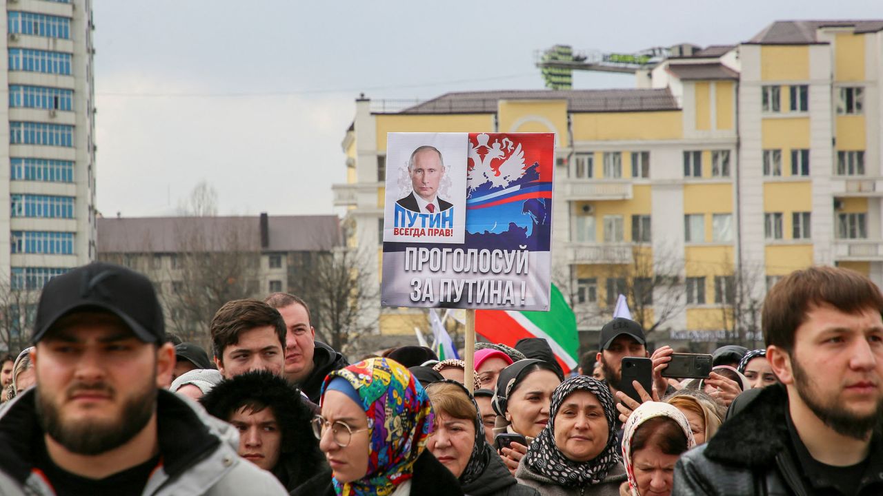 People, including supporters of Russian incumbent President and presidential candidate Vladimir Putin, take part in a procession organized on the occasion of the upcoming presidential election, in the Chechen capital Grozny, Russia, March 10, 2024. A slogan next to the Russian President Vladimir Putin's portrait on the poster reads: "Putin is always right! Vote for Putin!". REUTERS/Chingis Kondarov