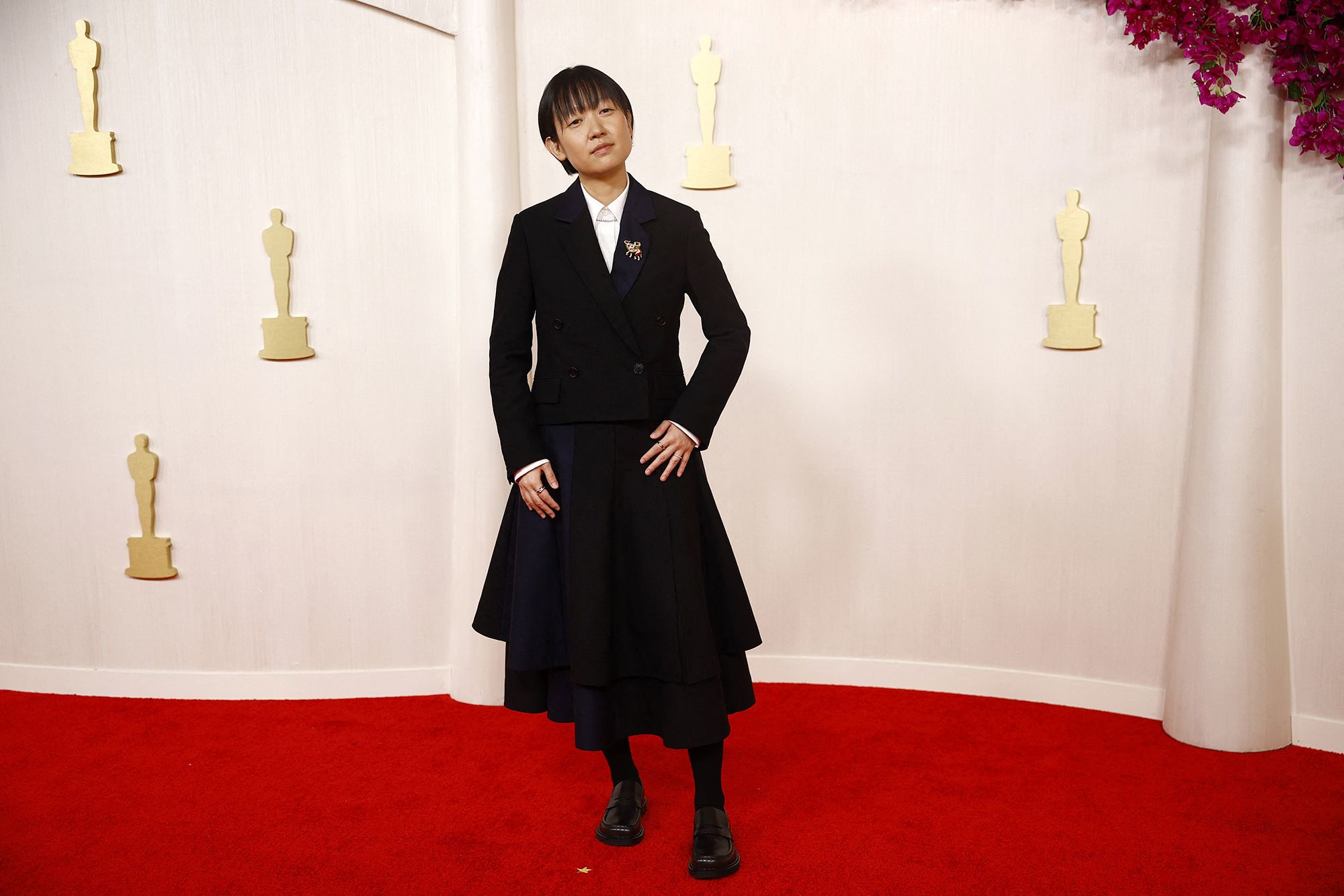 “Past Lives” director Celine Song wore a chic Loewe that paired a chic jacket with a pleated skirt.