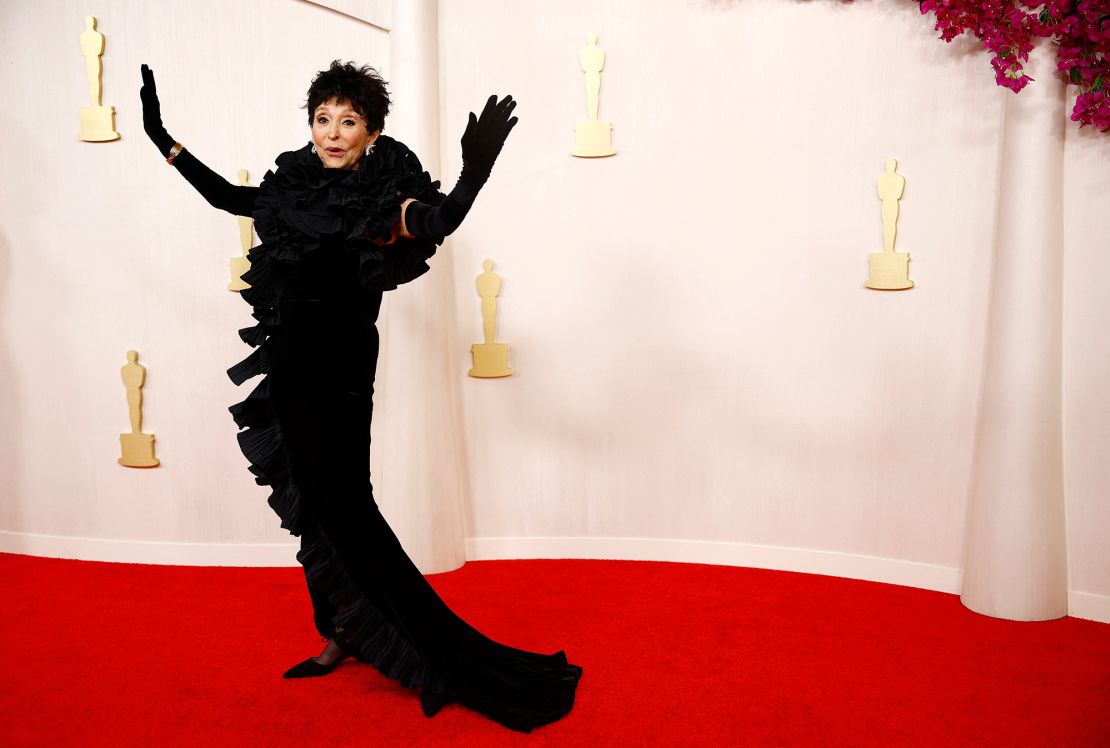 Actress Rita Moreno, 92, wore a black hourglass dress from the brand Badgley Mischka paired with a pair of elegant evening gloves.