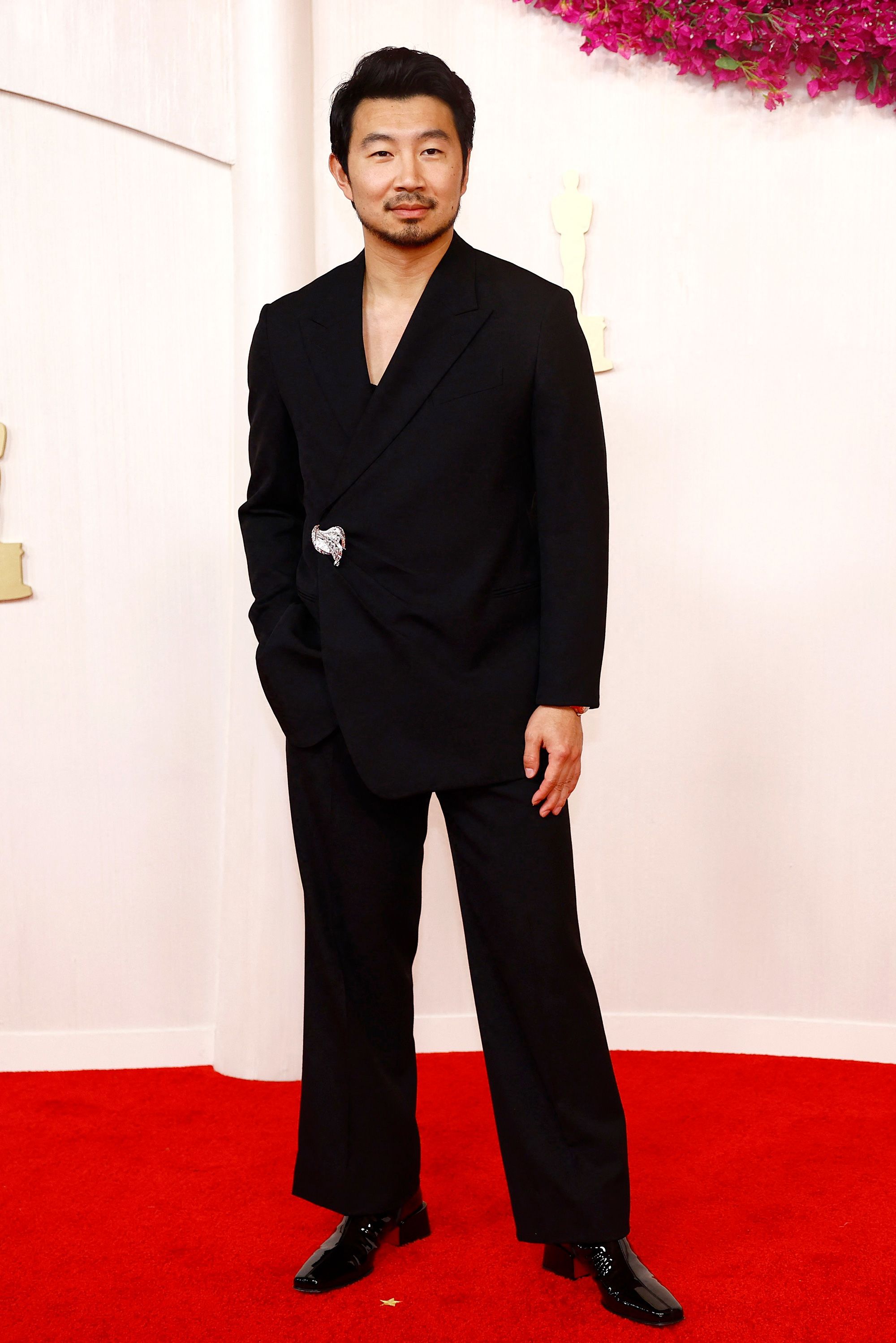 “Barbie” actor Simu Liu wore a black Fendi tuxedo with a low-cut tank top underneath.