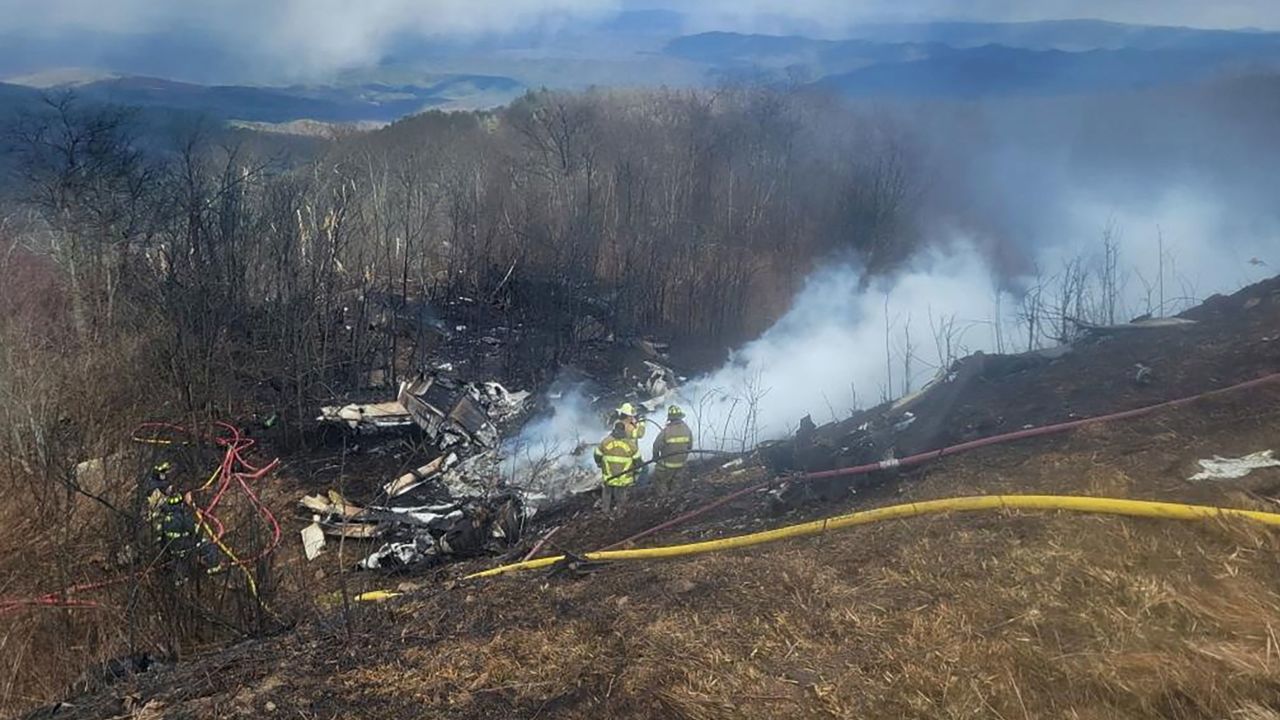 An emergency crew works at the site of a jet crash in Hot Springs, Virginia, on March 10.