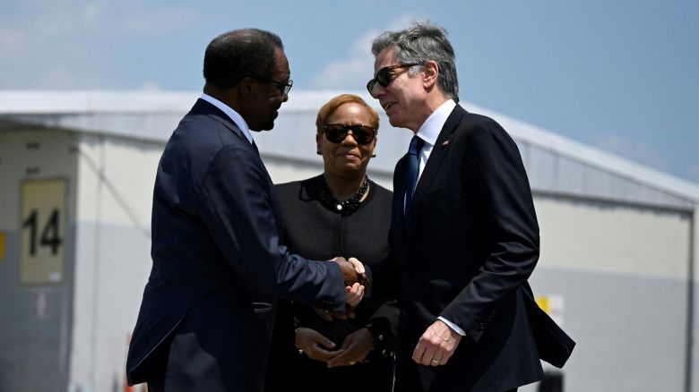US Secretary of State Antony Blinken is greeted by US Ambassador to Jamaica, N. Nick Perry upon arrival at Norman Manley International Airport, in Kingston, Jamaica, on March 11.