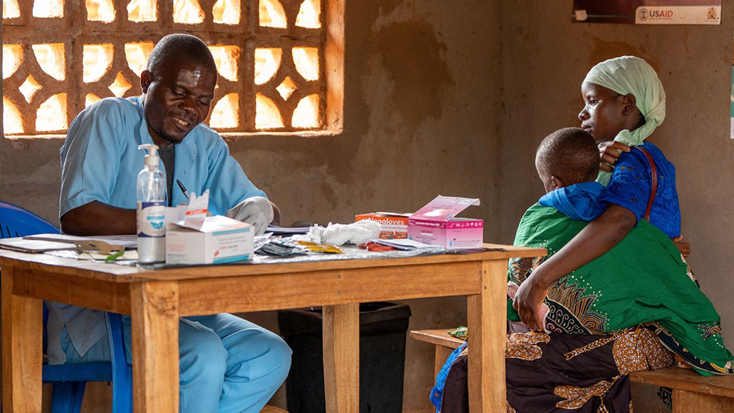 A health worker writes down a child's details after testing for malaria in Lilongwe, Malawi, in an undated photo.