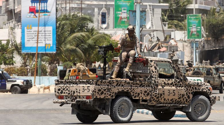A Somali security officer holds a position on a truck near Syl Hotel, the scene of an attack in Mogadishu on Friday.