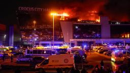 Ambulances and vehicles of Russian emergency services are parked at the burning Crocus City Hall concert venue following a shooting incident, outside Moscow, Russia, March 22, 2024.