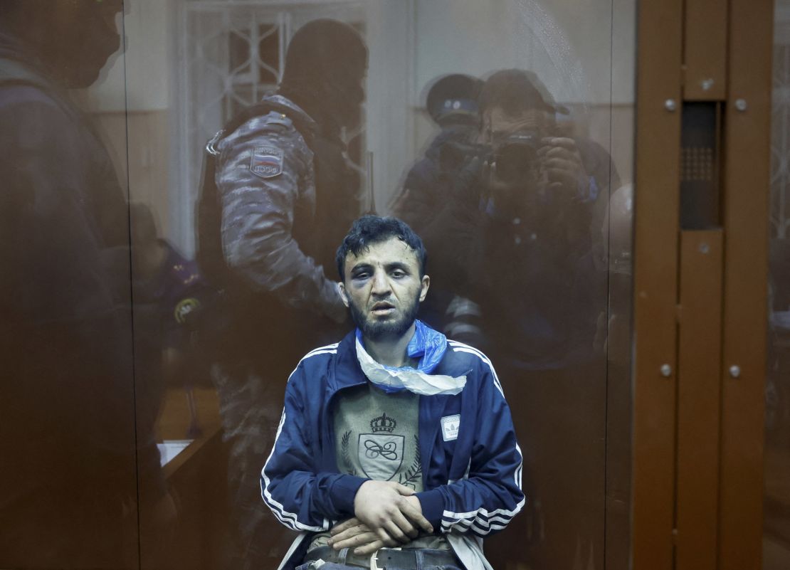 Dalerdzhon Mirzoyev, a suspect in the shooting attack at the Crocus City Hall concert venue, sits behind a glass wall of an enclosure for defendants at the Basmanny district court in Moscow, March 24, 2024.