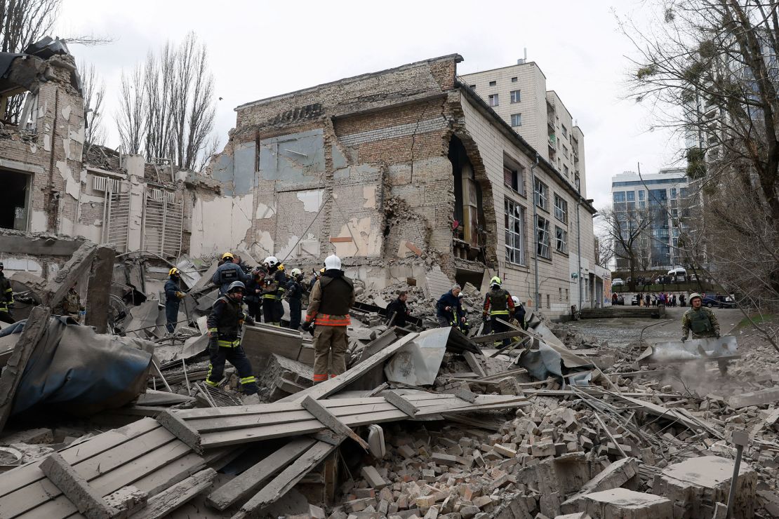 Rescuers workers sift through the rubble after Monday's hypersonic missile strike on Kyiv.