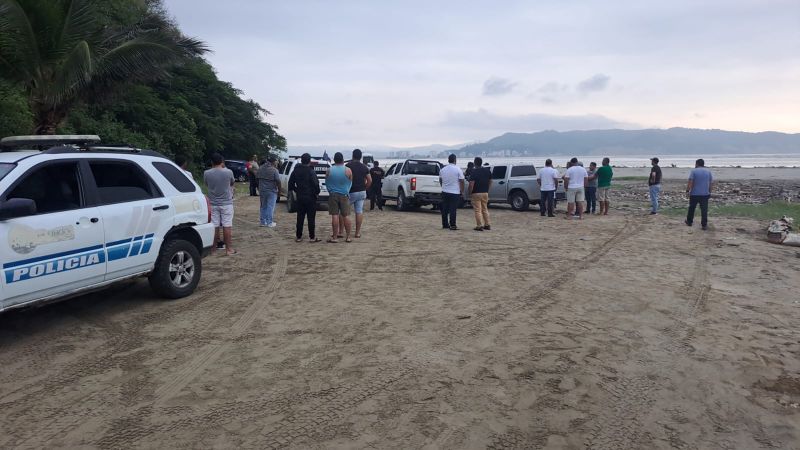 Ecuadorian police and people gather at the scene where Ecuador's youngest mayor, Brigitte Garcia was found shot dead in a car, according to the police, near San Vicente, Ecuador, in this handout image released on March 24, 2024.
