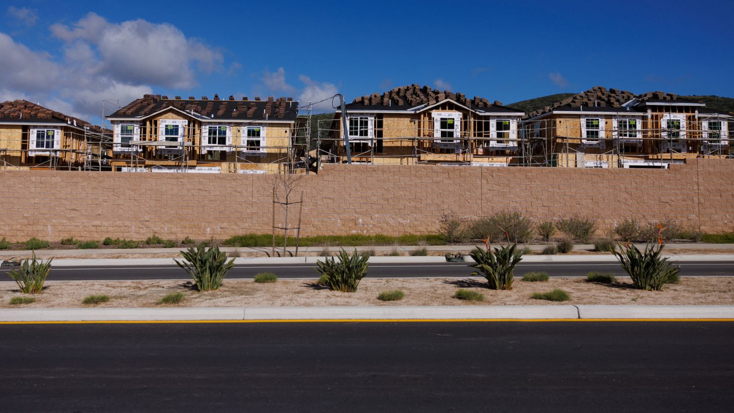 Scaffoldings are set up around single-family residential homes under construction in San Marcos, California, in March.