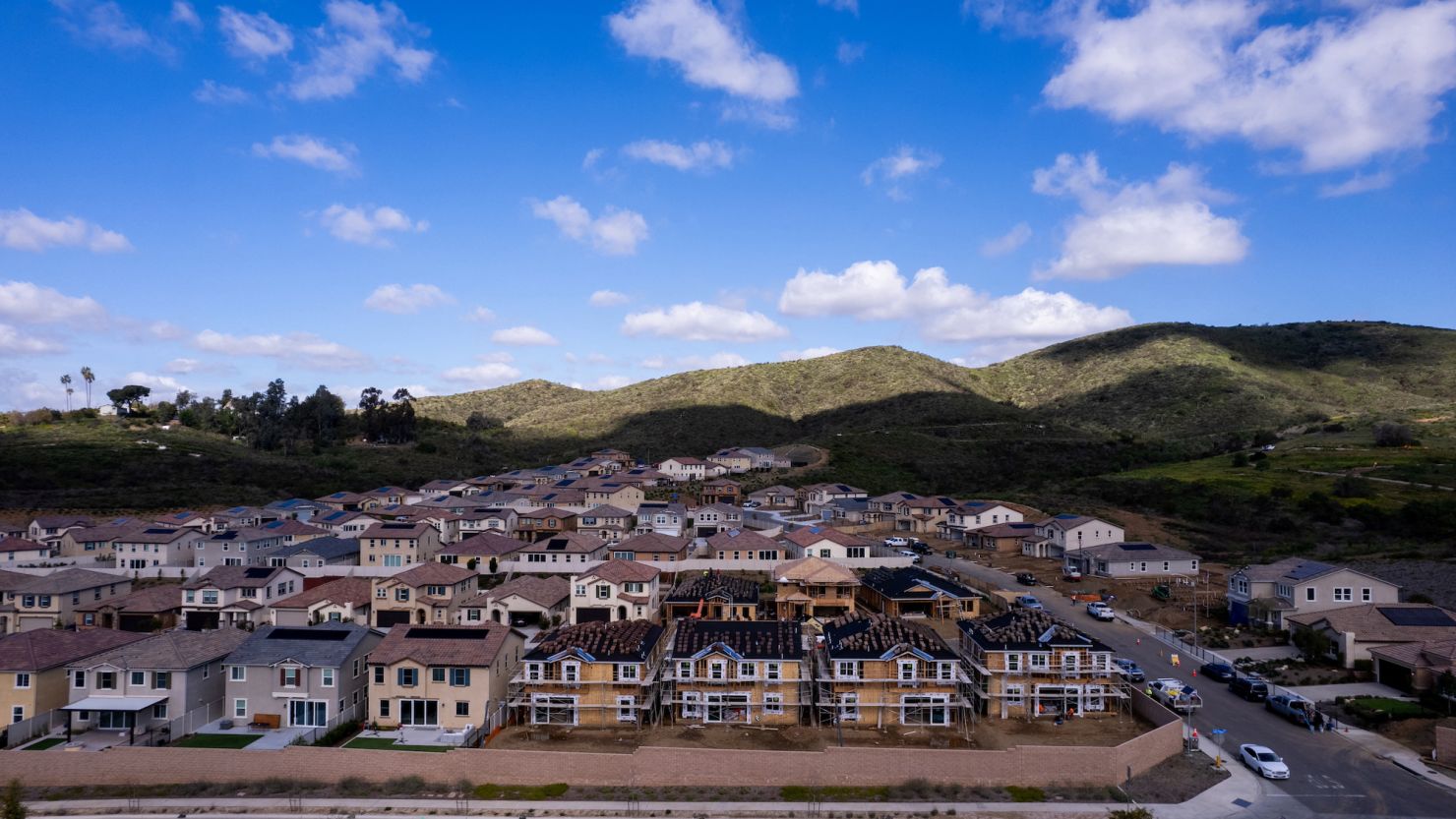 A drone view shows single-family homes at a new subdivision under construction in the rural hills of San Marcos, California, in March.