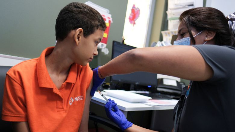 A registered nurse, Kayla Feliciano injects a dose of the dengue vaccine Dengvaxia to Alberto Luis Nunez, 12, after a spike in dengue fever cases in San Juan, Puerto Rico, March 27, 2024.