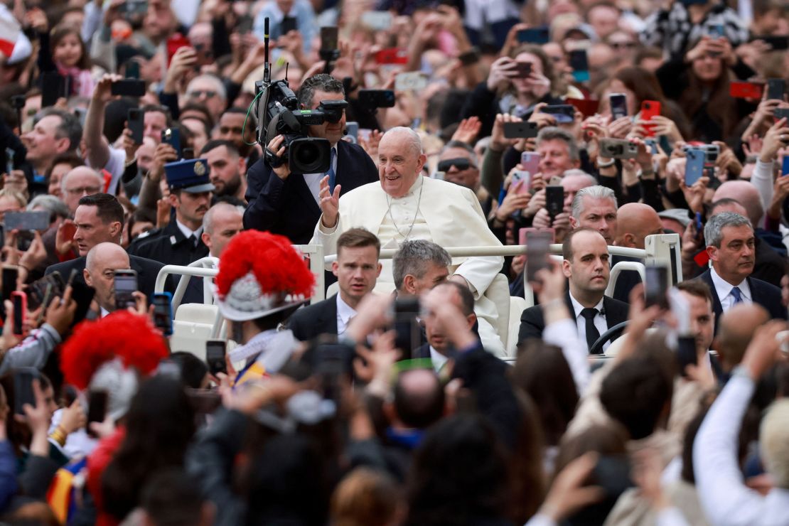 Pope Francis waves at onlookers from St. Peter's Square.