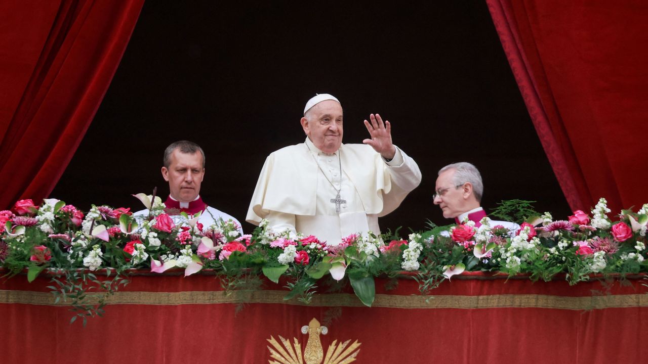 Pope Francis waves from a balcony, on the day he delivers his "Urbi et Orbi" (To the city and the world) message at St. Peter's Square, on Easter Sunday, at the Vatican March 31, 2024.